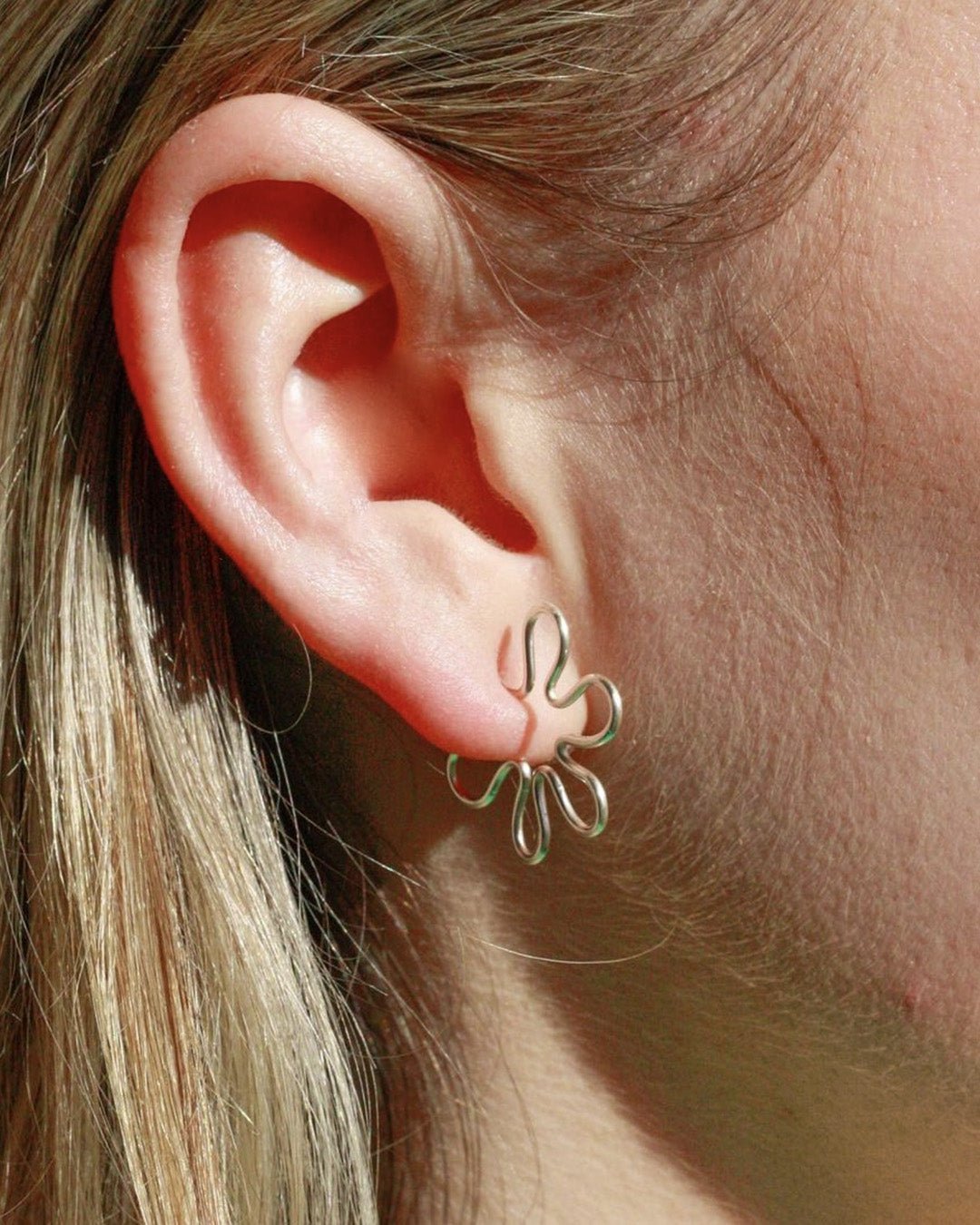 Funki Studios Silver Earrings on ears